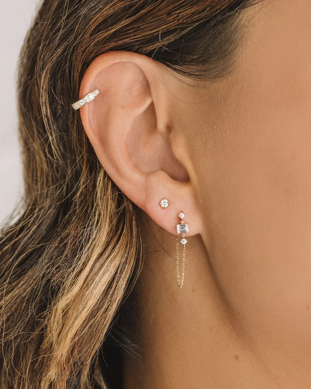 Emerald Cut and Round Brilliant drop earrings with 0.30 carats* of diamond simulants in 10 carat yellow gold